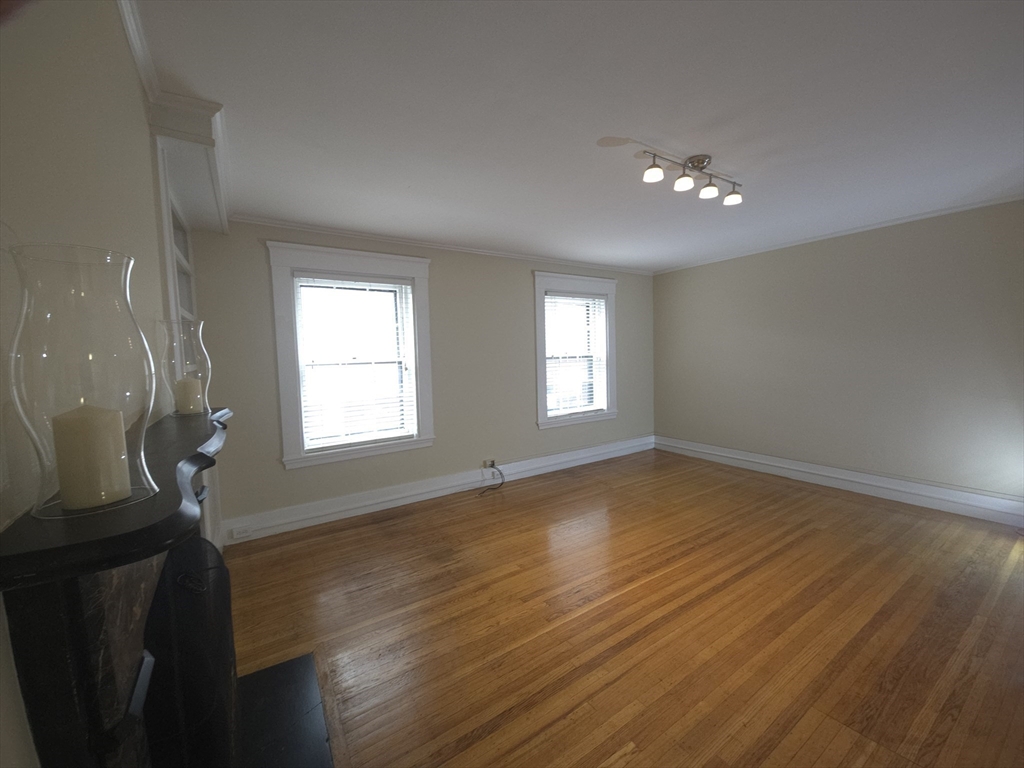 75 Charles Street, Unit 4B Boston, MA 02114 - Photo 3 of 14 a view of empty room with wooden floor and fan