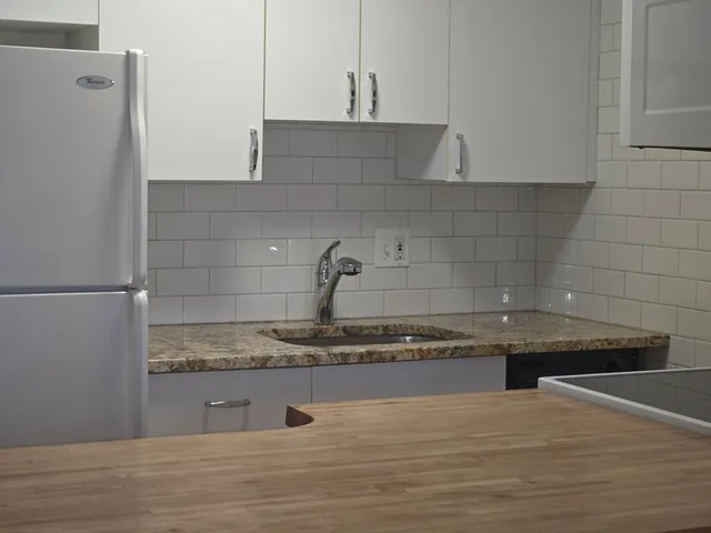 a kitchen with a sink and cabinets