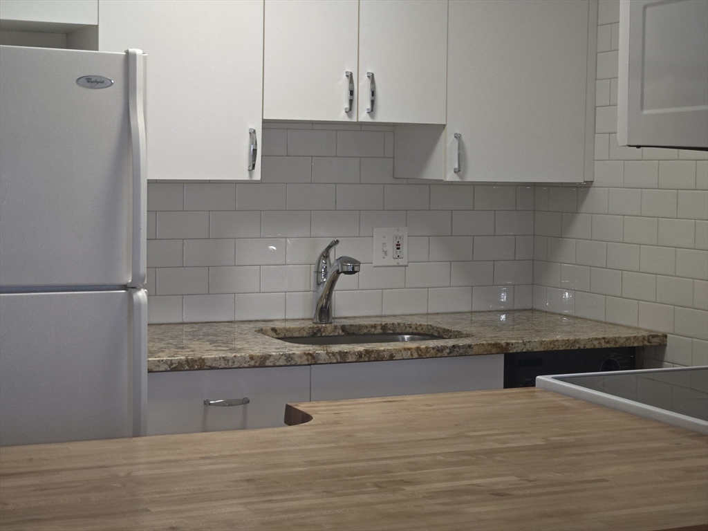 75 Charles Street, Unit 4B Boston, MA 02114 - Photo 6 of 14 a kitchen with a sink and cabinets