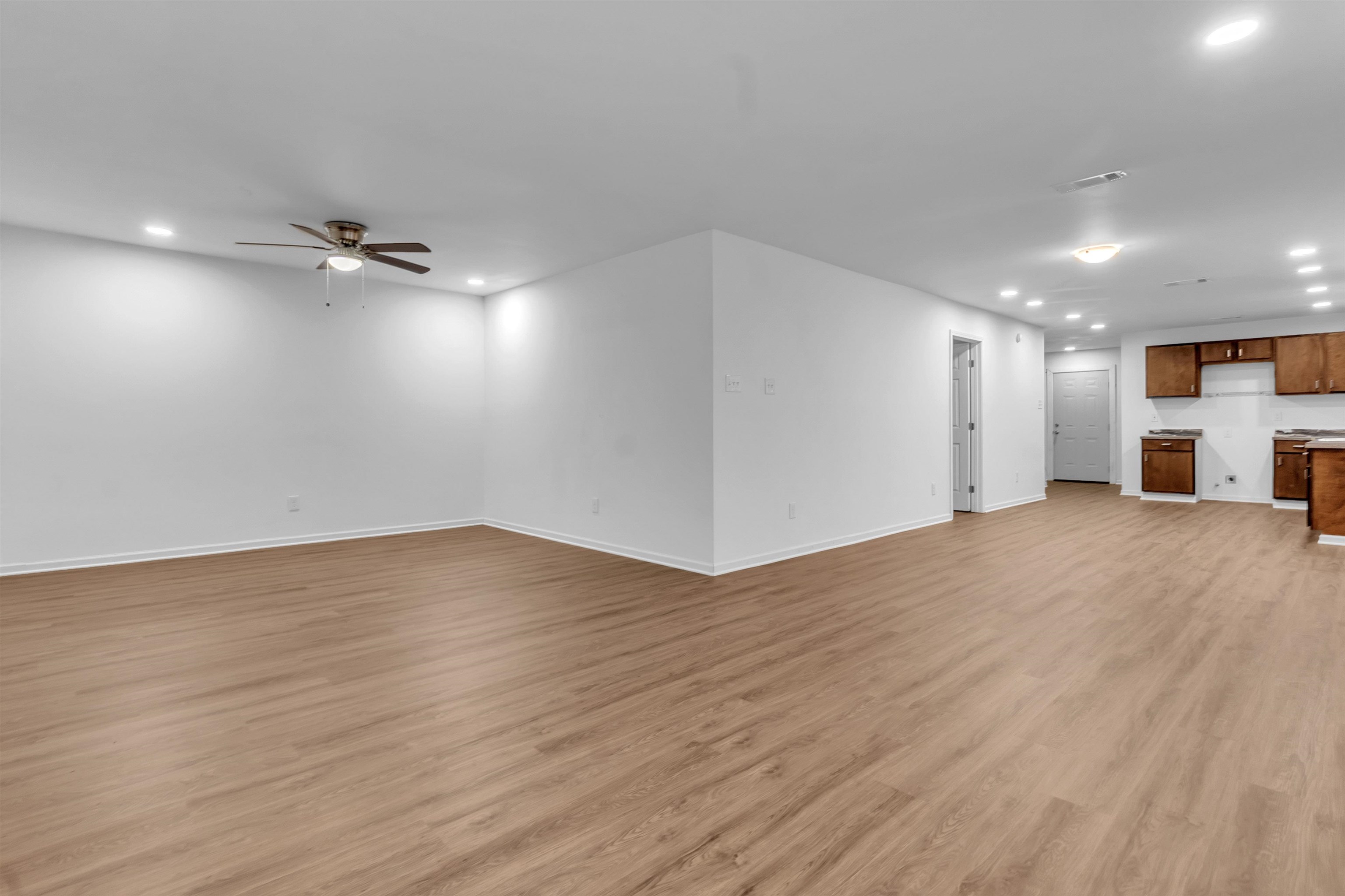 3021 Chelsea Avenue Memphis, TN 38108 - Photo 11 of 17 Unfurnished living room with recessed lighting, light wood-style flooring, and ceiling fan