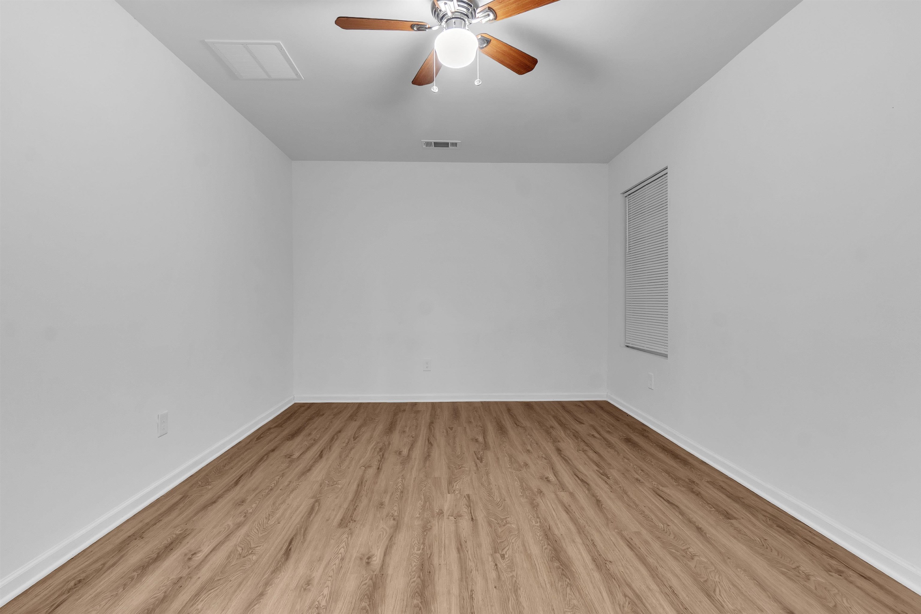 3021 Chelsea Avenue Memphis, TN 38108 - Photo 4 of 17 Empty room with light wood-style flooring and ceiling fan