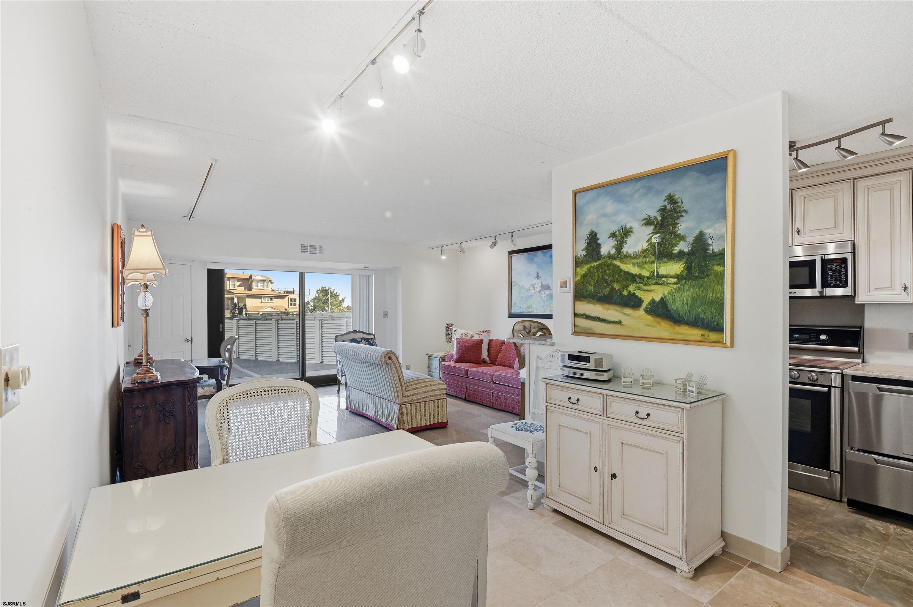 2700 Atlantic Avenue, Unit 209 Longport, NJ 08403 - Photo 14 of 31 a living room with furniture and flat screen tv