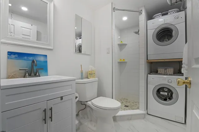 a white toilet sitting next to a bathroom sink