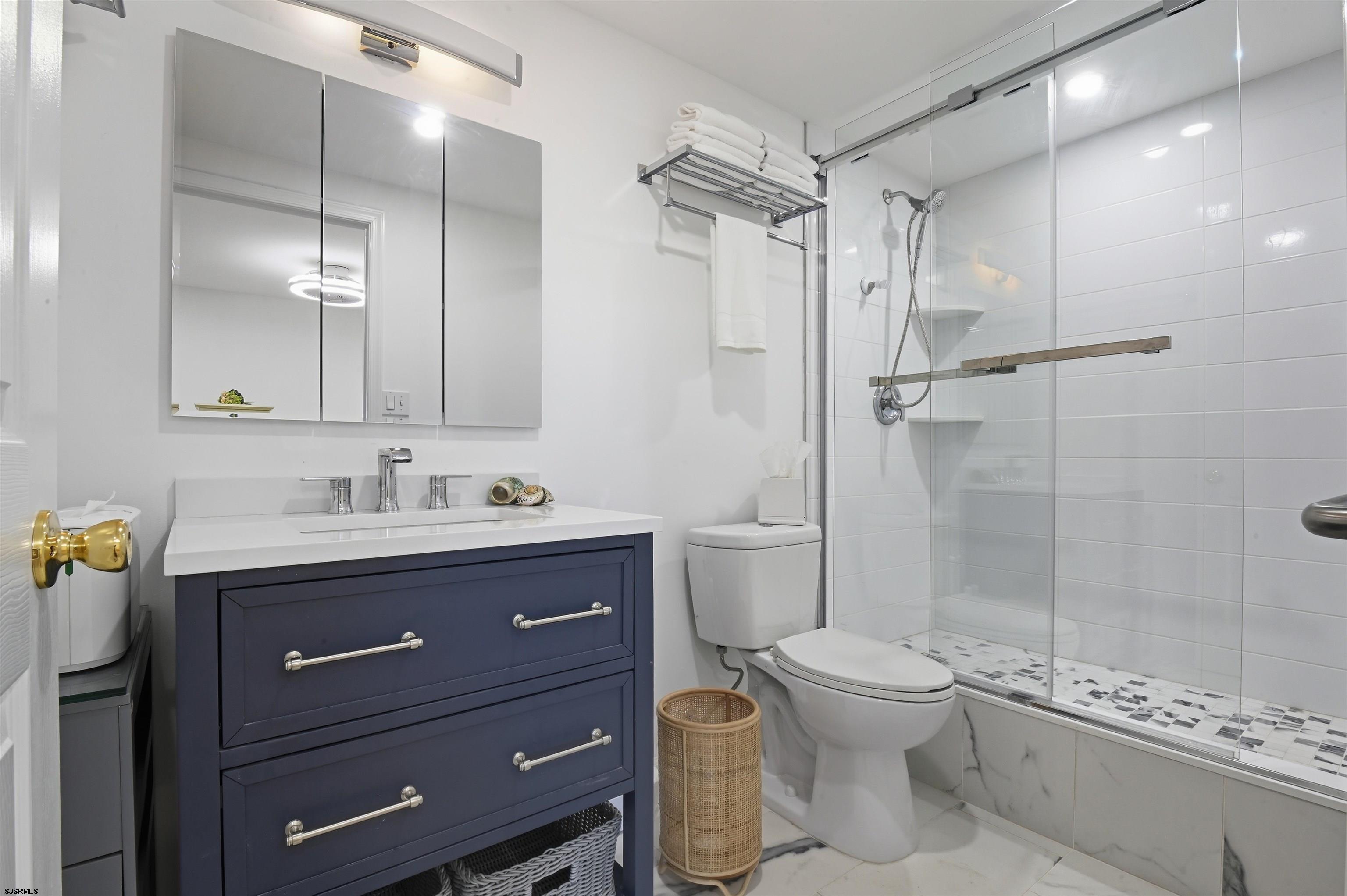 2700 Atlantic Avenue, Unit 209 Longport, NJ 08403 - Photo 23 of 31 a bathroom with a sink a toilet and shower