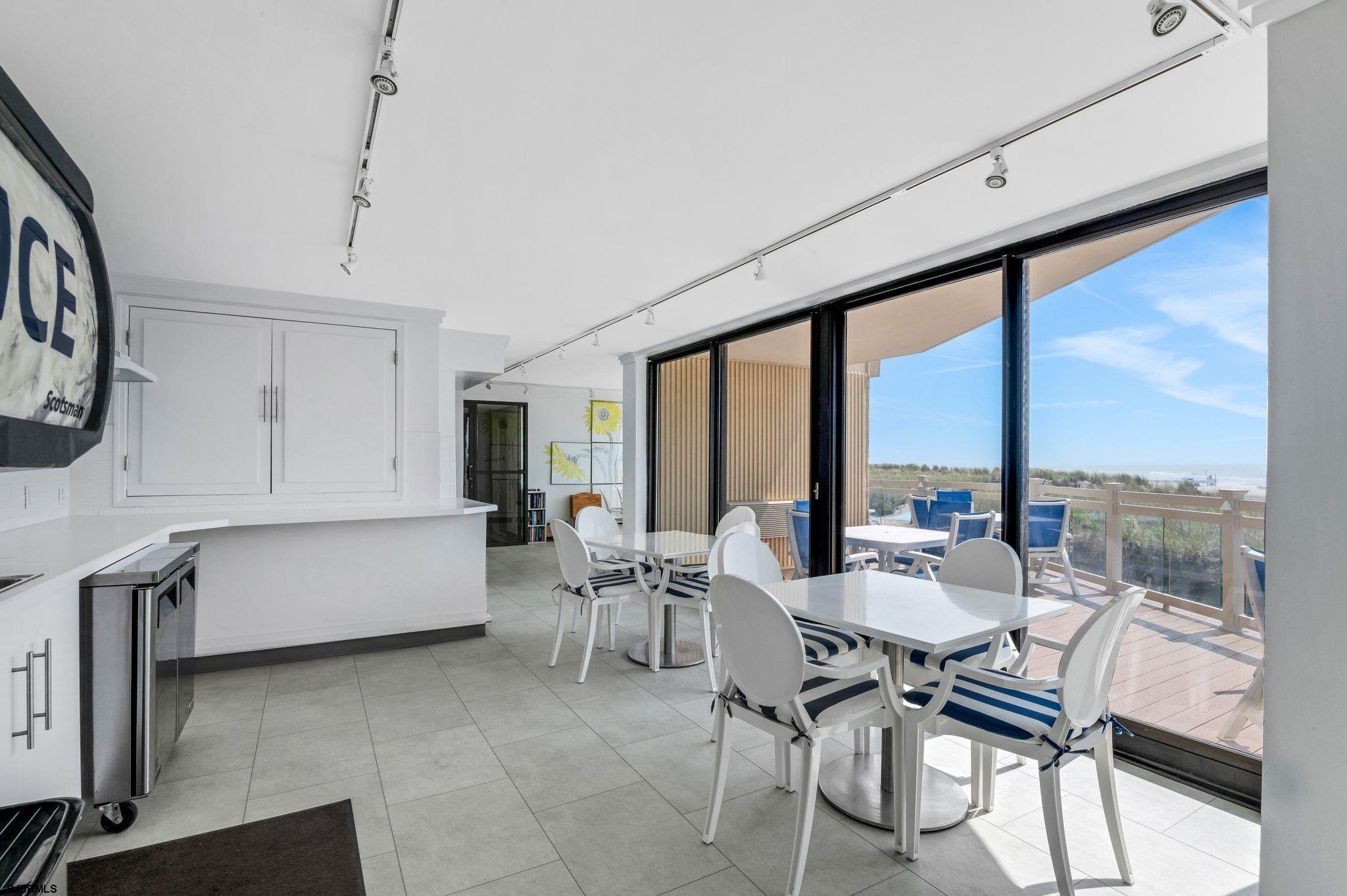 2700 Atlantic Avenue, Unit 209 Longport, NJ 08403 - Photo 26 of 31 a dining room with furniture and a large window