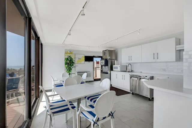 a kitchen with cabinets table and chairs