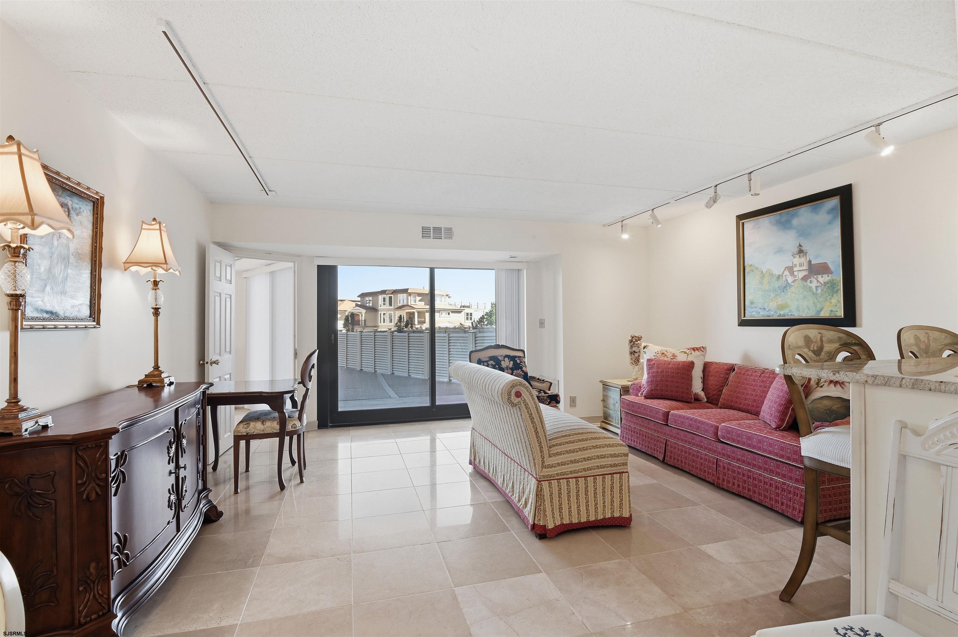 2700 Atlantic Avenue, Unit 209 Longport, NJ 08403 - Photo 4 of 31 a living room with furniture and a wooden floor