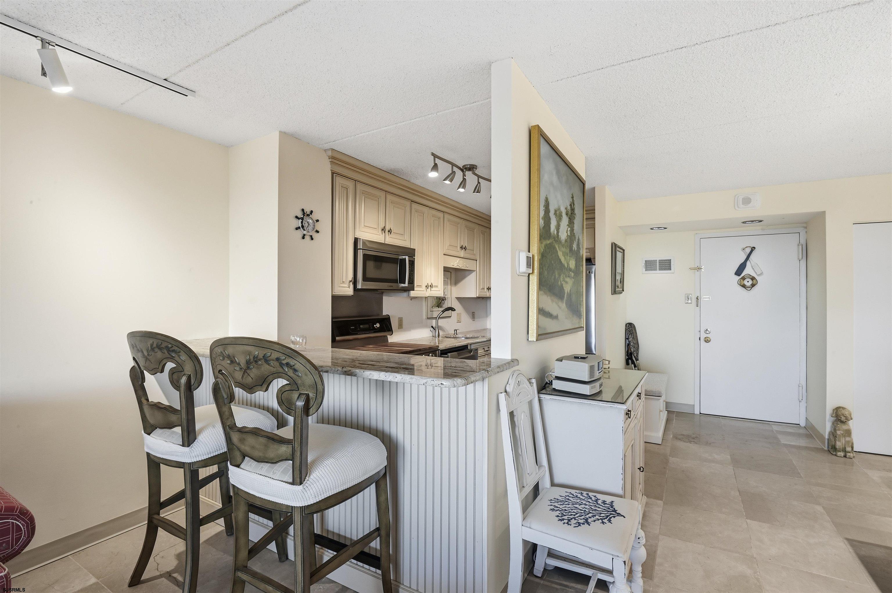 2700 Atlantic Avenue, Unit 209 Longport, NJ 08403 - Photo 10 of 31 a view of a livingroom with furniture and a flat screen tv