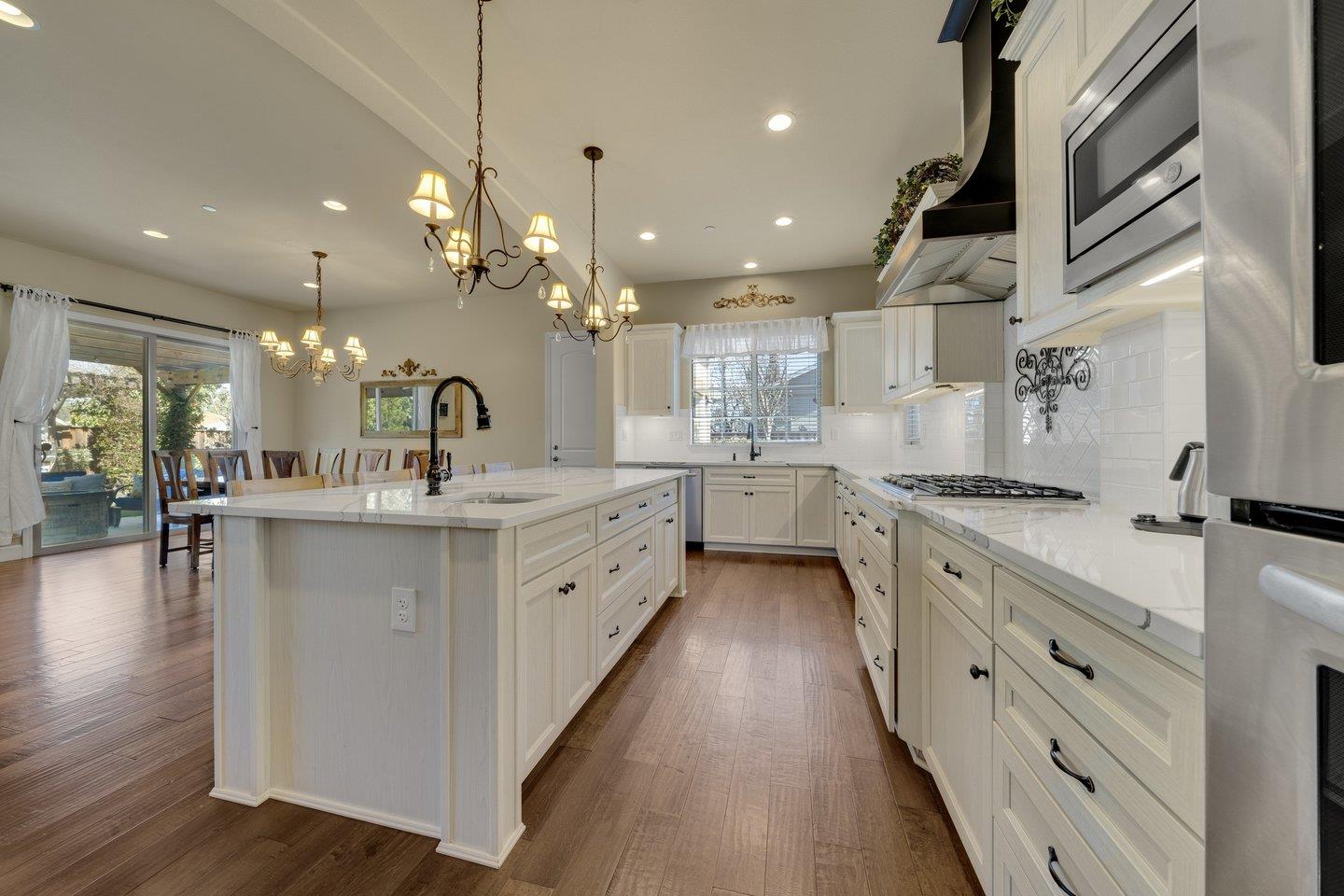 3943 Vía Cristobal Campbell, CA 95008 - Photo 12 of 59 a large kitchen with kitchen island lots of counter space a sink dining table and chairs
