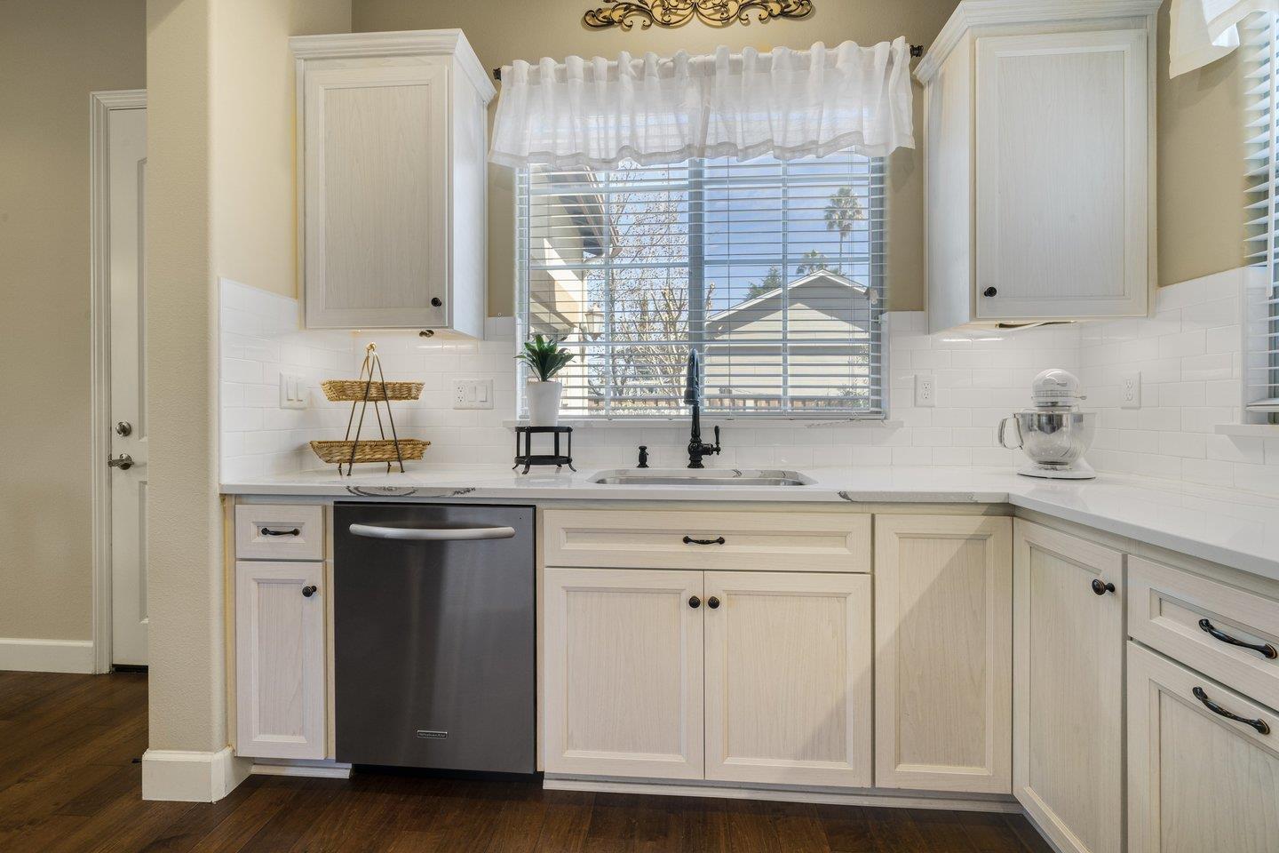 3943 Vía Cristobal Campbell, CA 95008 - Photo 15 of 59 a kitchen with stainless steel appliances white cabinets and a window