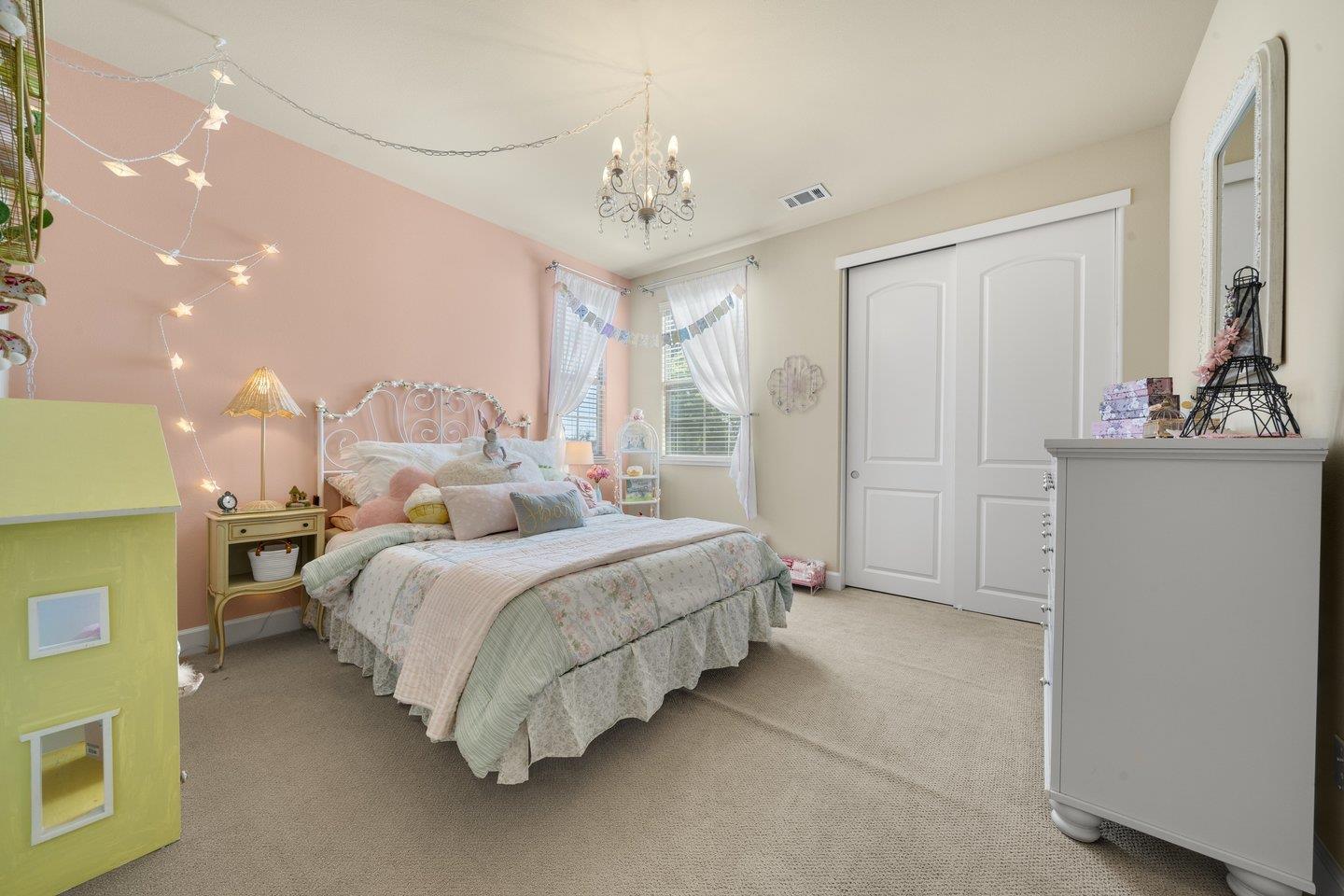 3943 Vía Cristobal Campbell, CA 95008 - Photo 36 of 59 a spacious bedroom with a bed and a chandelier