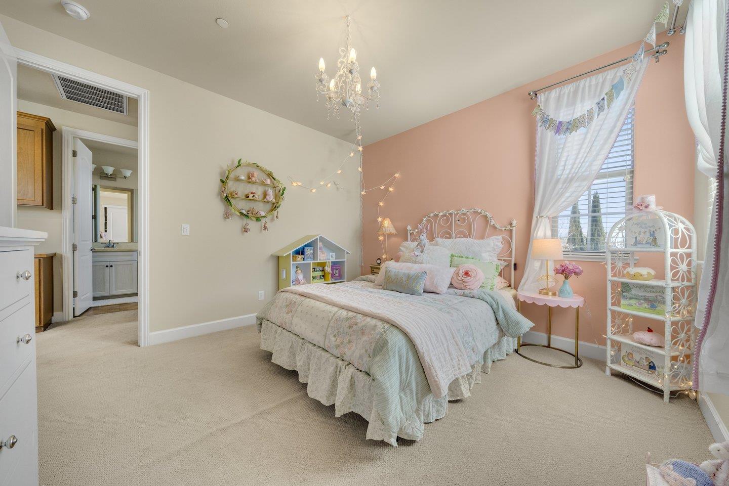 3943 Vía Cristobal Campbell, CA 95008 - Photo 37 of 59 a spacious bedroom with a bed and a chandelier