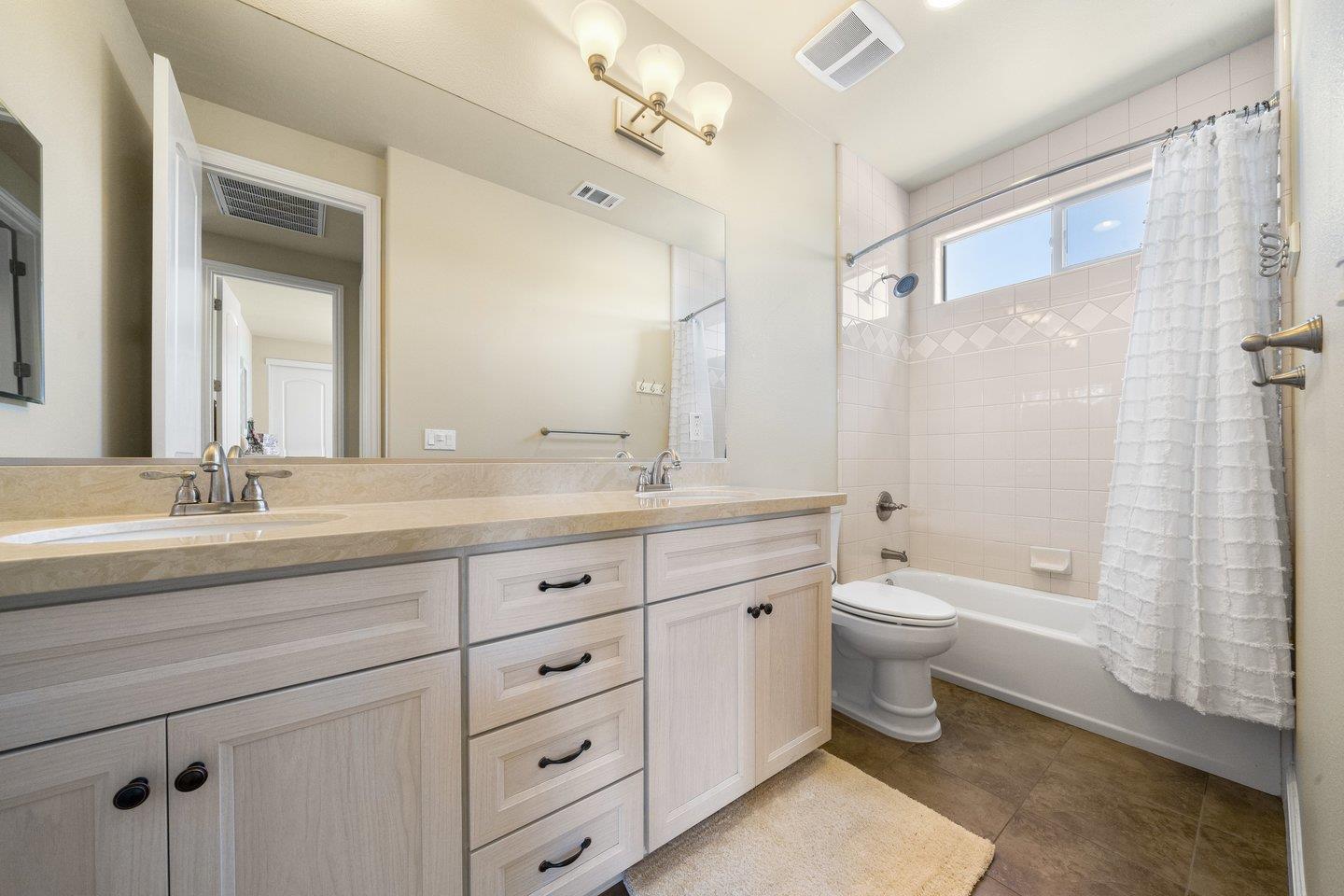 3943 Vía Cristobal Campbell, CA 95008 - Photo 38 of 59 a bathroom with a double vanity sink toilet mirror and bathtub