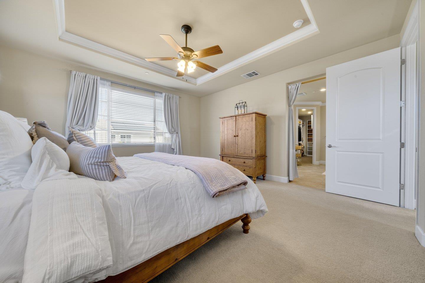 3943 Vía Cristobal Campbell, CA 95008 - Photo 43 of 59 a spacious bedroom with a bed and a chandelier