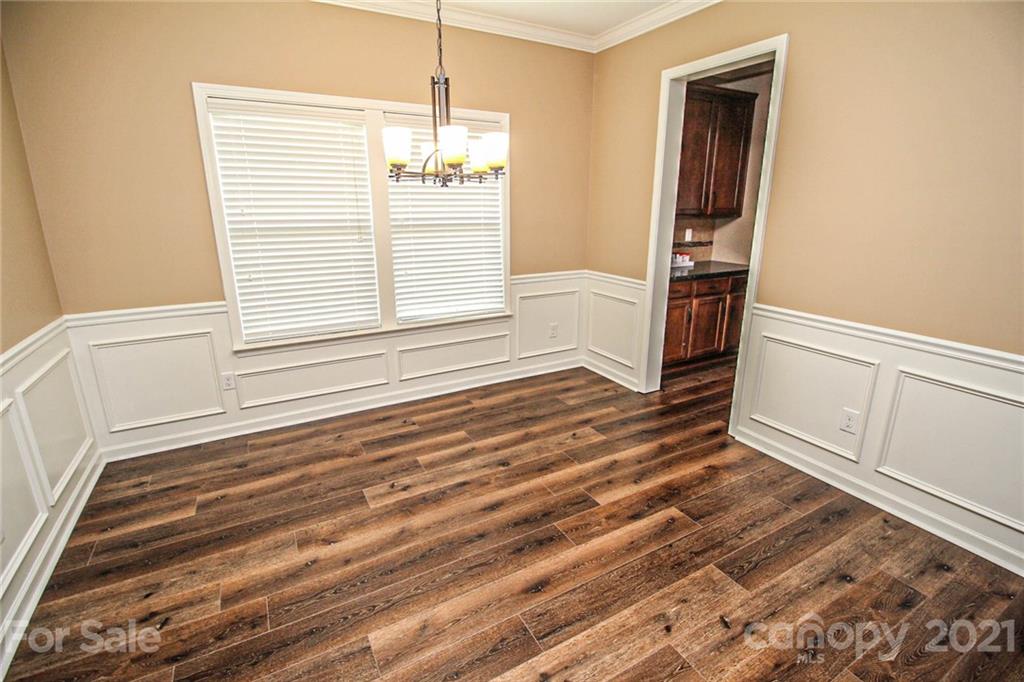 7042 Meyer Road Fort Mill, SC 29715 - Photo 3 of 18 a view of empty room with wooden floor and fan