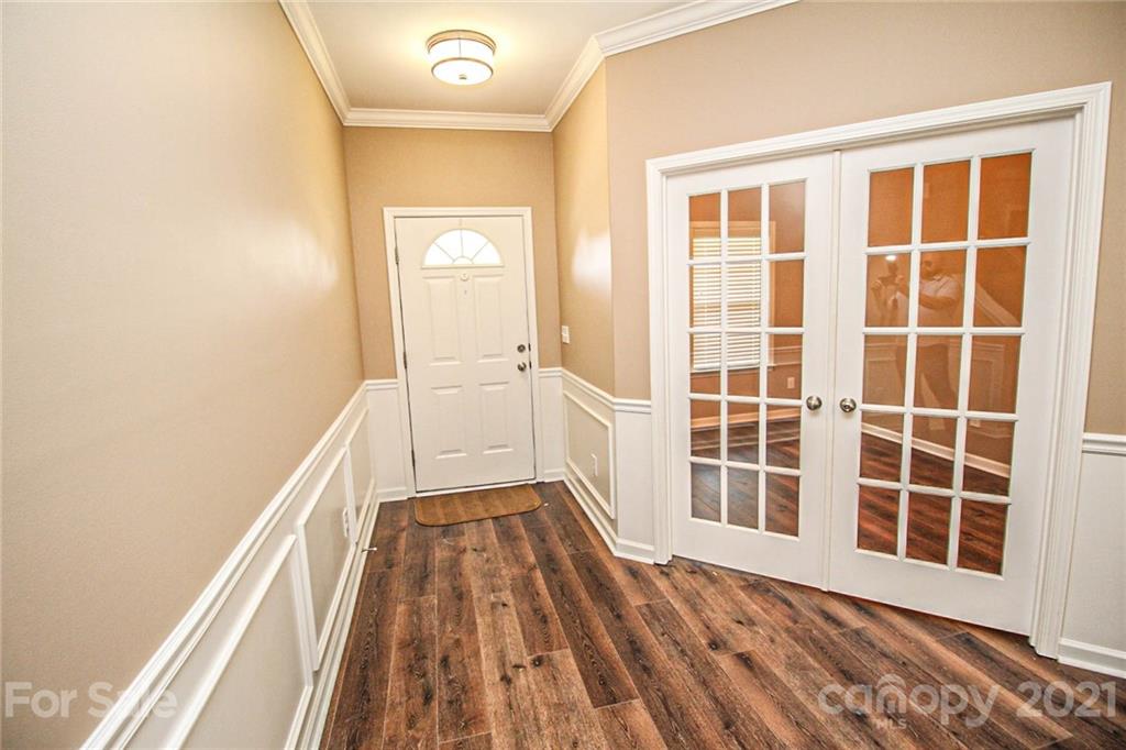 7042 Meyer Road Fort Mill, SC 29715 - Photo 4 of 18 a view of a bedroom with wooden floor and windows