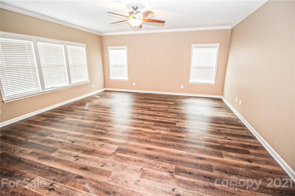 7042 Meyer Road Fort Mill, SC 29715 - Photo 8 of 18 a view of an empty room with wooden floor and a window