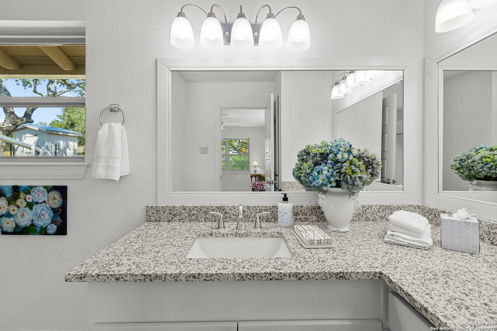 935 Spring Branch Road Spring Branch, TX 78070 - Photo 16 of 48 a bathroom with a granite countertop sink and a mirror