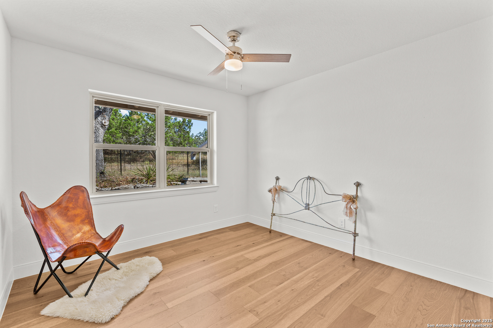 935 Spring Branch Road Spring Branch, TX 78070 - Photo 19 of 48 a workspace with wooden floor and a window