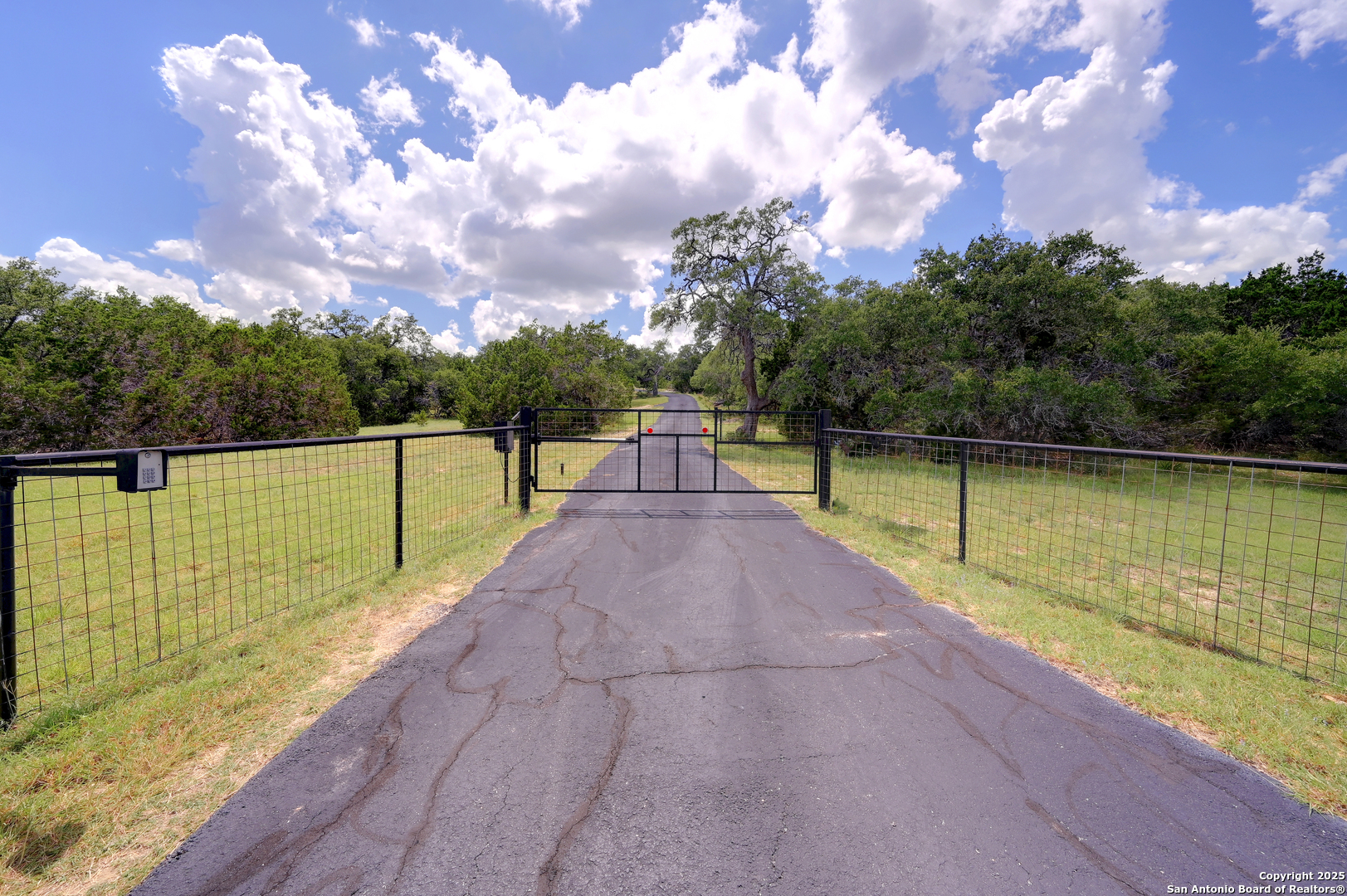 935 Spring Branch Road Spring Branch, TX 78070 - Photo 2 of 48 a view of a lake with a swimming pool and a yard