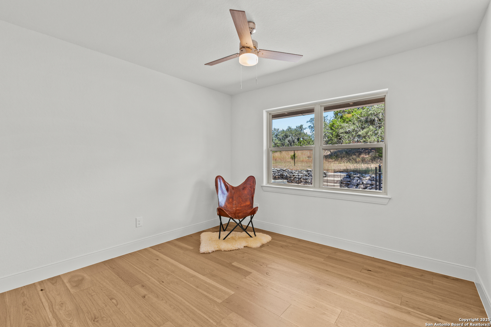 935 Spring Branch Road Spring Branch, TX 78070 - Photo 23 of 48 a workspace with wooden floor and a window