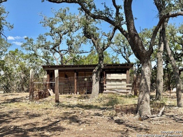 935 Spring Branch Road Spring Branch, TX 78070 - Photo 44 of 48 a front view of a house with a yard and garage