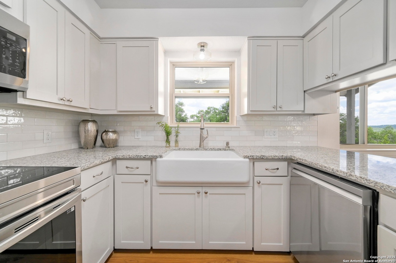 935 Spring Branch Road Spring Branch, TX 78070 - Photo 10 of 48 a kitchen with white cabinets and white appliances