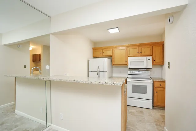 a kitchen with a stove a sink and a refrigerator