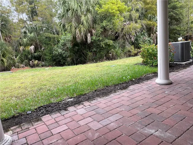 a view of a backyard with pathway