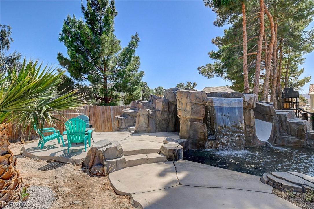 3765 Berkeley Street Logandale, NV 89021 - Photo 75 of 87 This private outdoor space features a custom rock waterfall and slide, perfect for enjoying sunny days.