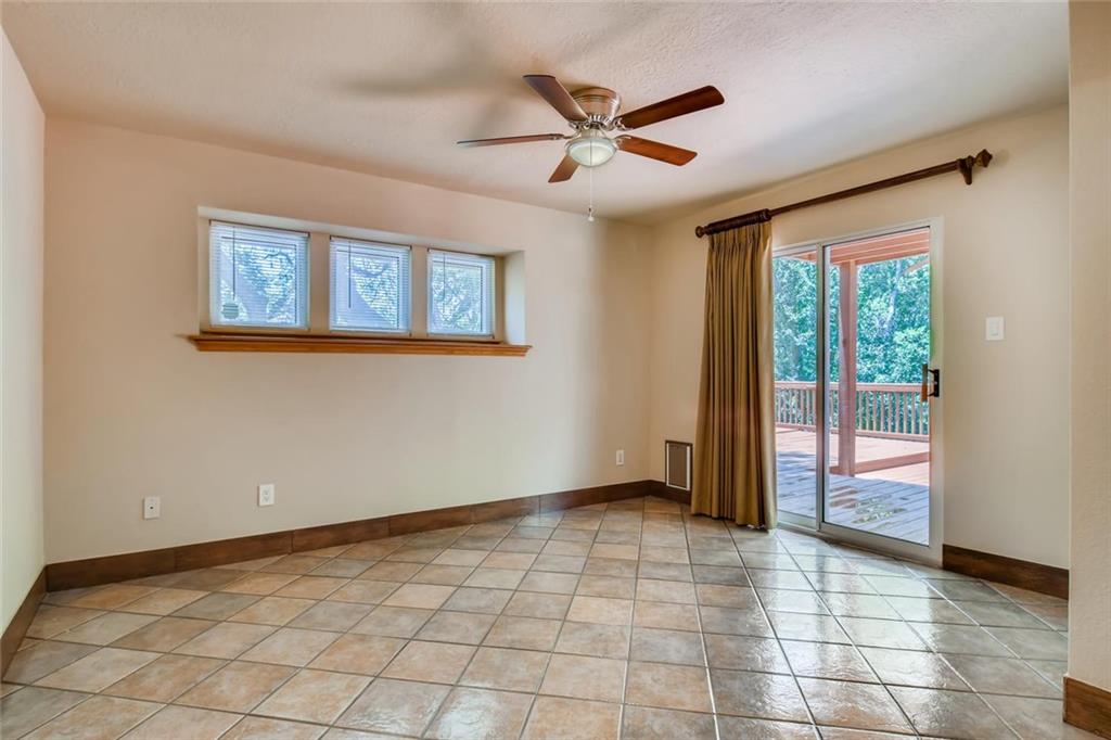 1600 Whitney Way Austin, TX 78741 - Photo 14 of 26 Empty room featuring healthy amount of natural light, ceiling fan, and light tile patterned floors