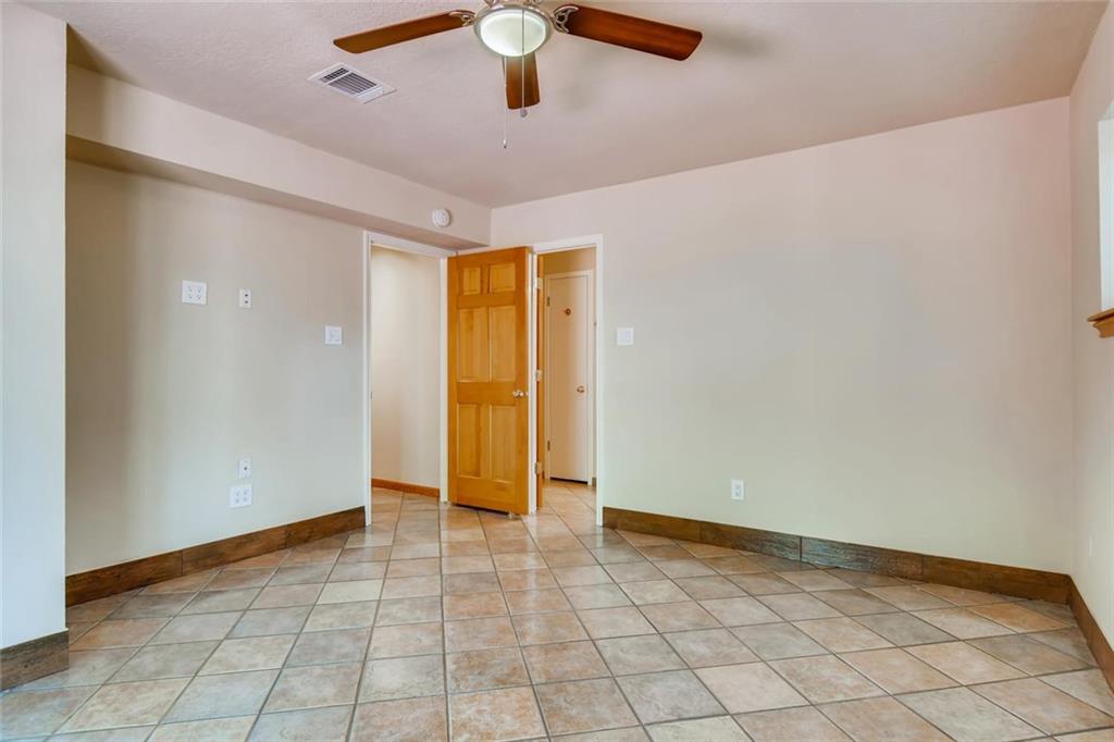 1600 Whitney Way Austin, TX 78741 - Photo 15 of 26 Spare room featuring a ceiling fan and light tile patterned flooring