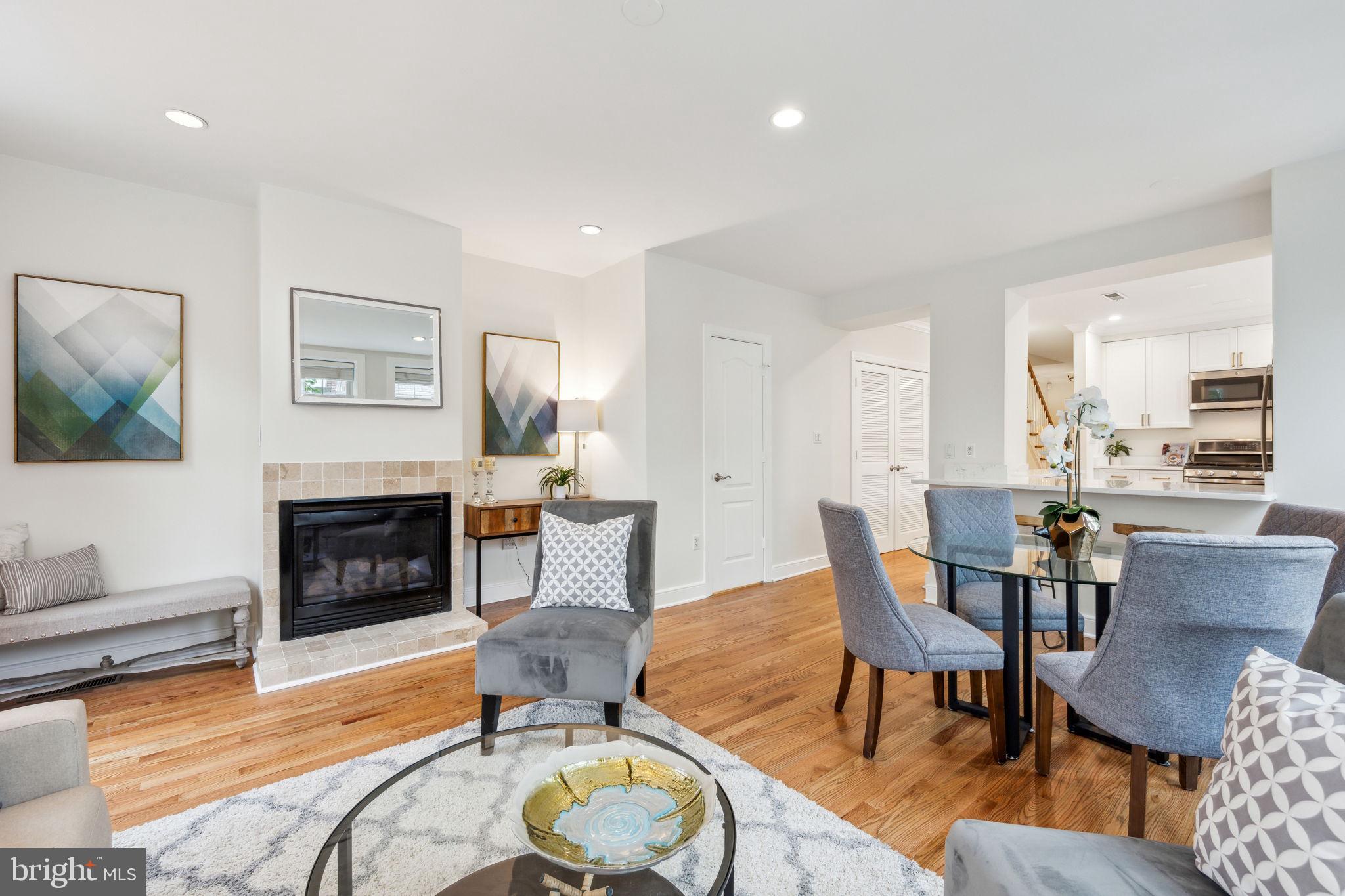 2444 Tunlaw Road Northwest Washington, DC 20007 - Photo 11 of 38 a living room with furniture a fireplace and a flat screen tv