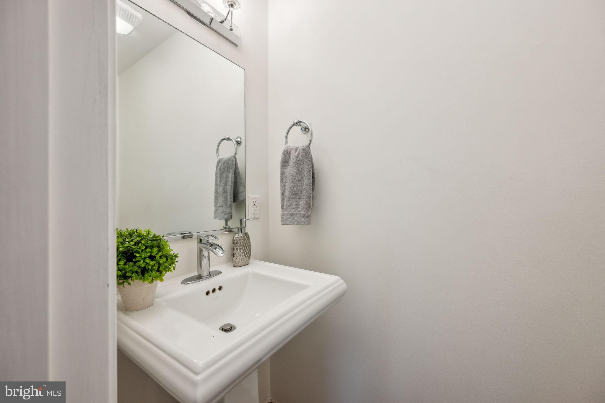2444 Tunlaw Road Northwest Washington, DC 20007 - Photo 13 of 38 a bathroom with a sink and a mirror