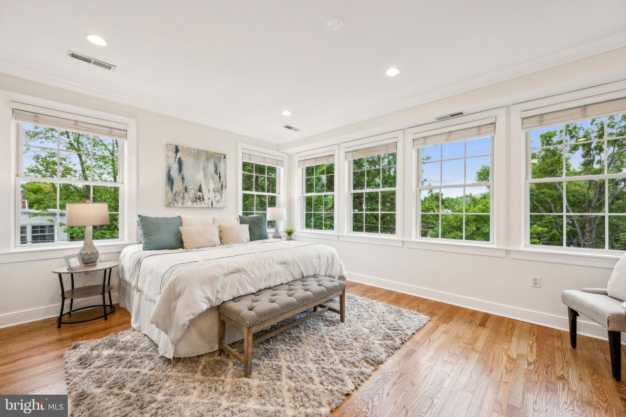 2444 Tunlaw Road Northwest Washington, DC 20007 - Photo 15 of 38 a spacious bedroom with a large bed and a large window