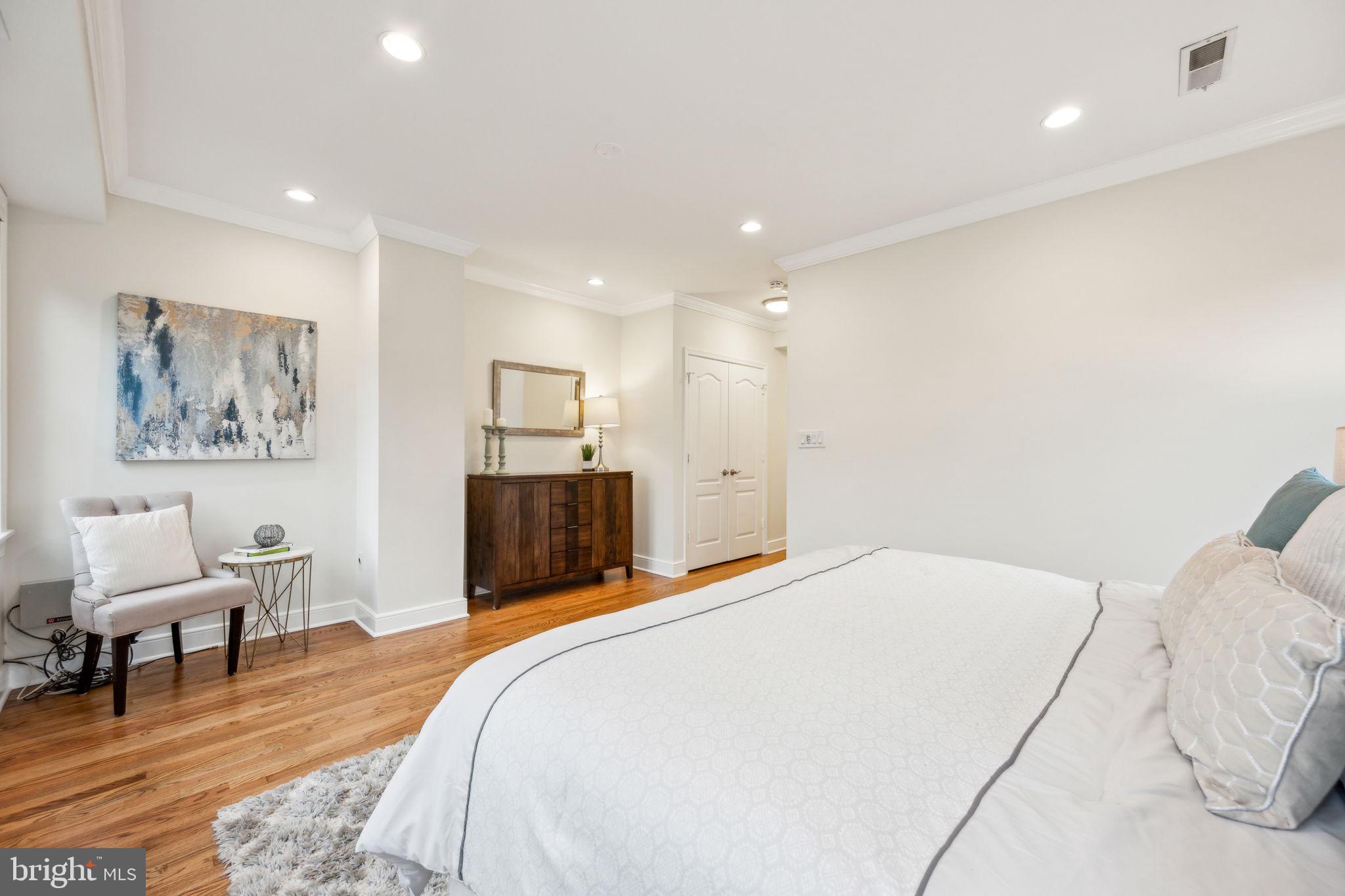2444 Tunlaw Road Northwest Washington, DC 20007 - Photo 20 of 38 a bedroom with a bed and a chair