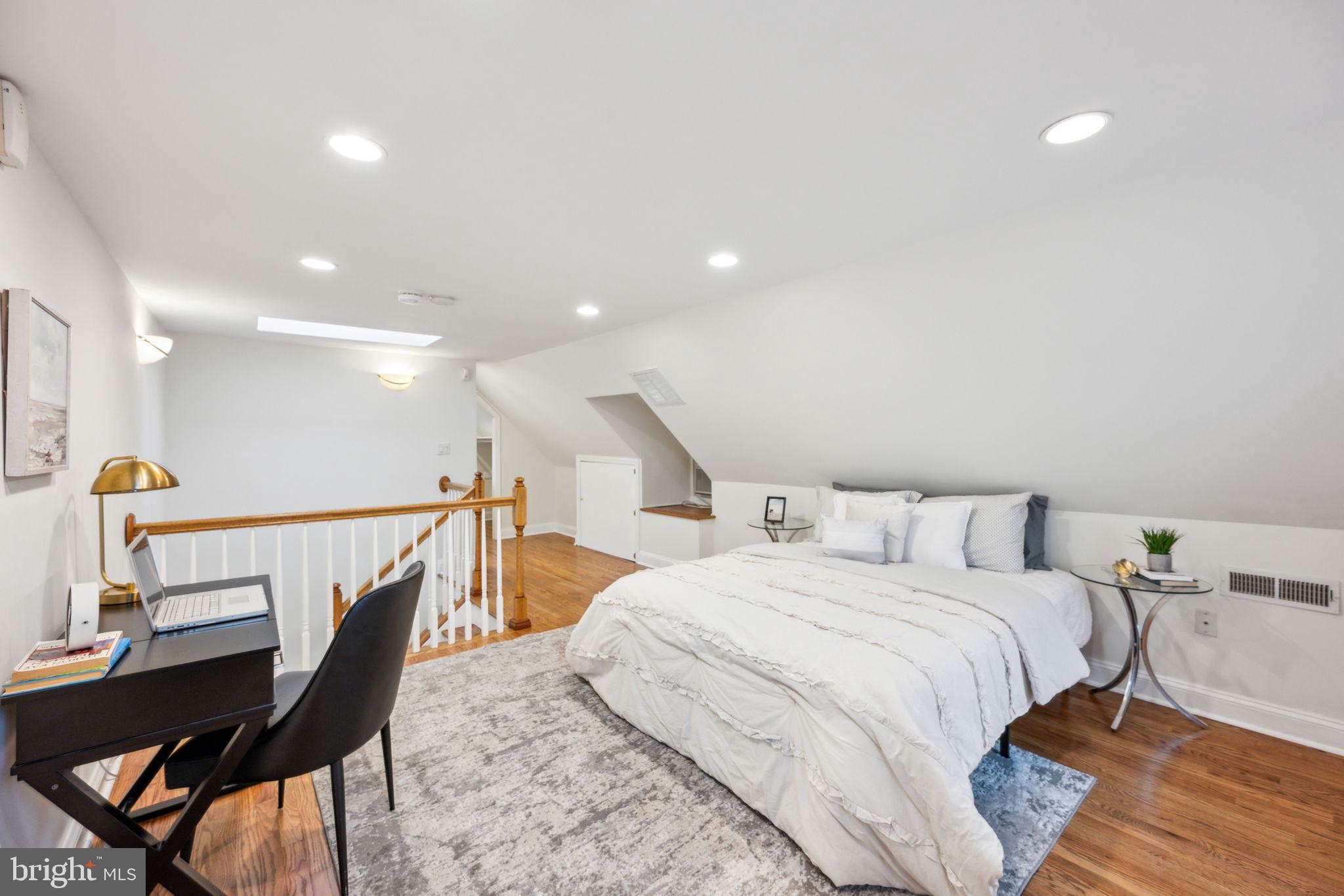 2444 Tunlaw Road Northwest Washington, DC 20007 - Photo 25 of 38 a bedroom with a bed a desk and chair