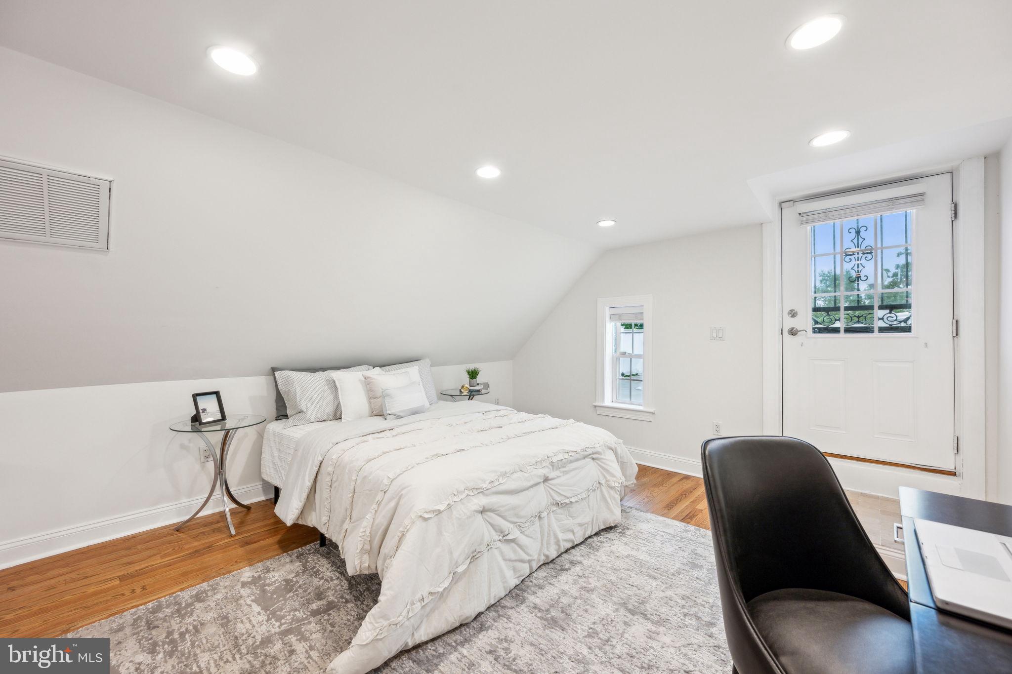 2444 Tunlaw Road Northwest Washington, DC 20007 - Photo 27 of 38 a bedroom with a bed and a chair