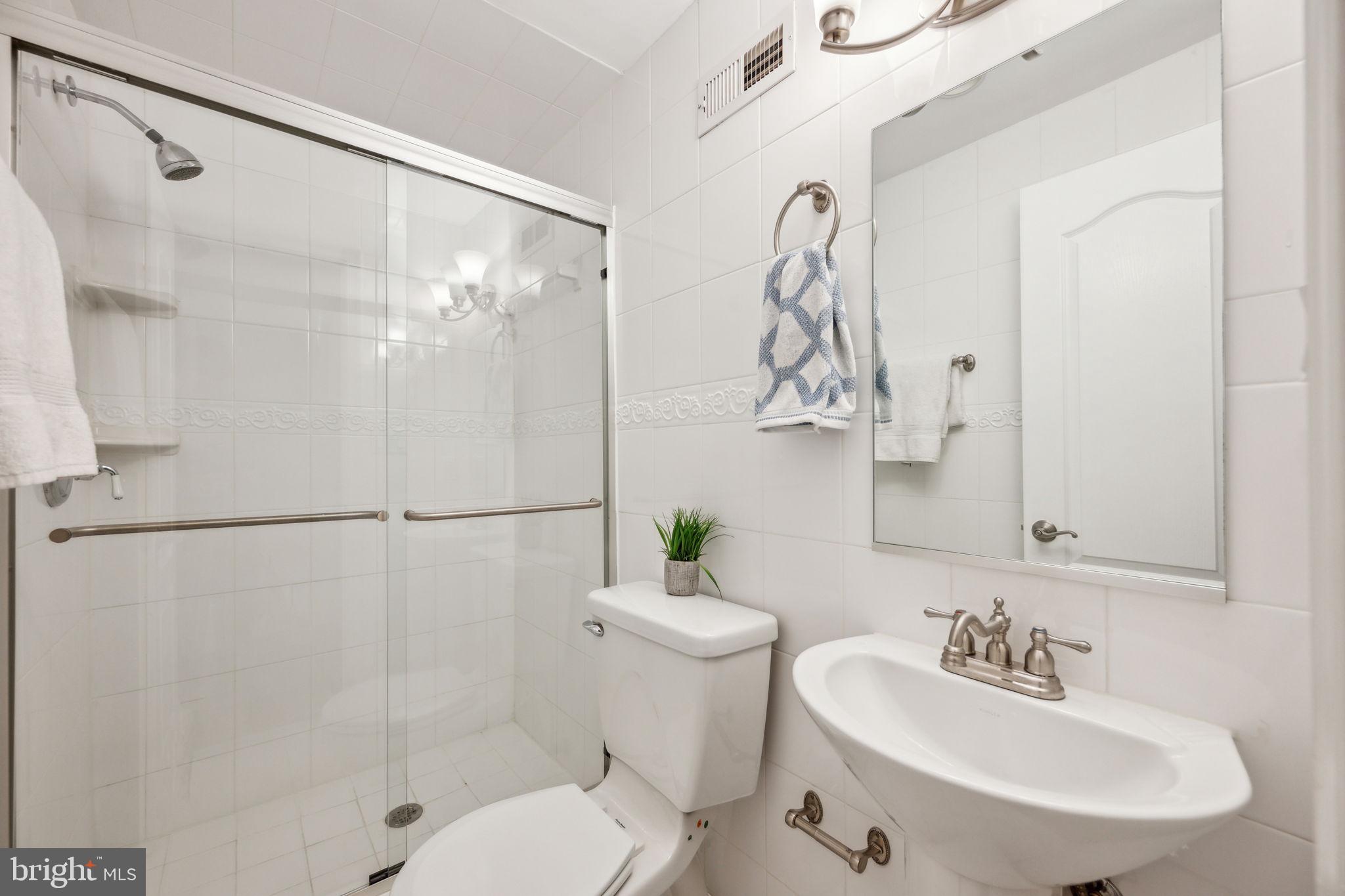 2444 Tunlaw Road Northwest Washington, DC 20007 - Photo 28 of 38 a bathroom with a sink a toilet and shower