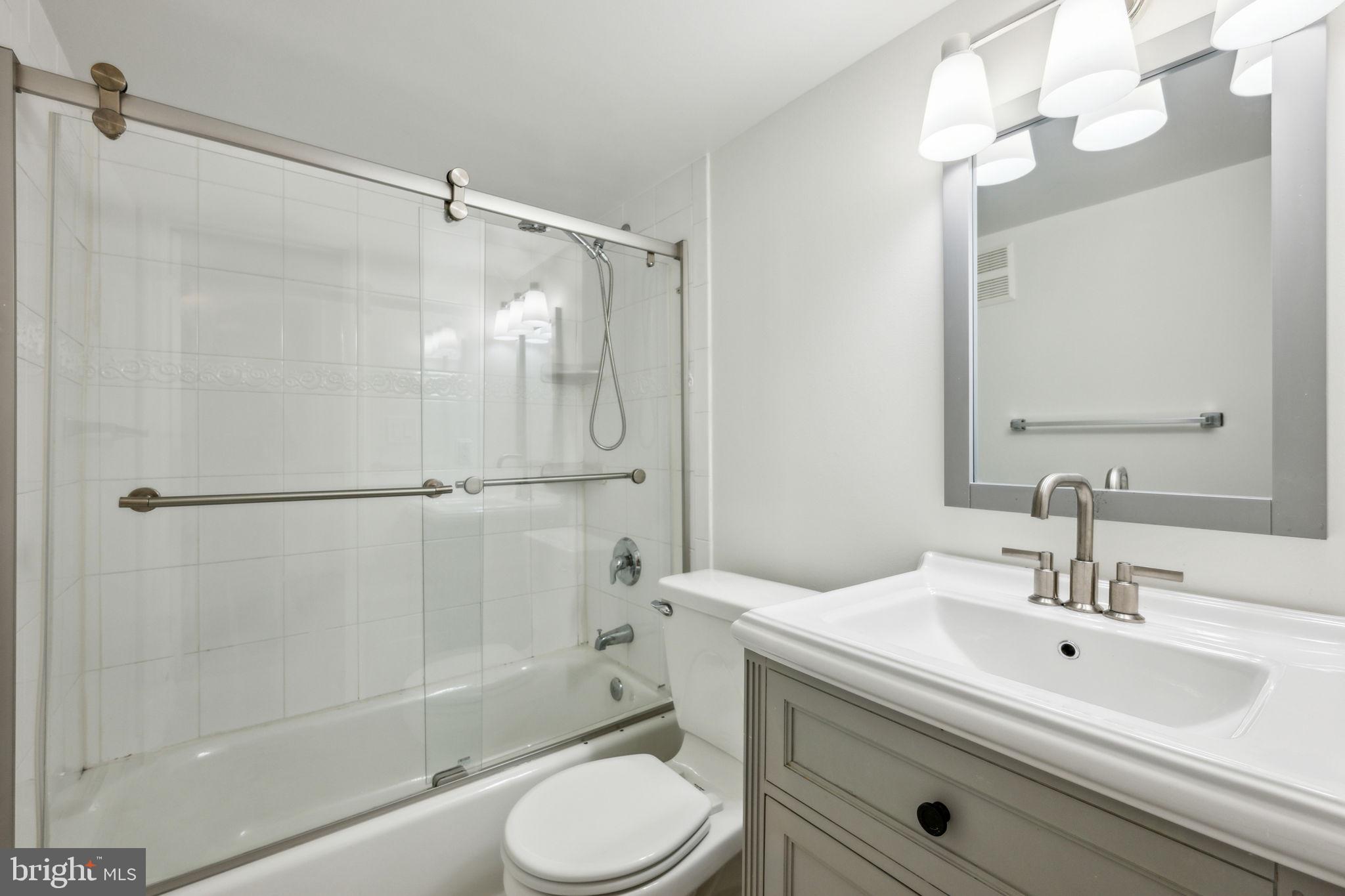2444 Tunlaw Road Northwest Washington, DC 20007 - Photo 35 of 38 a bathroom with a sink toilet and shower