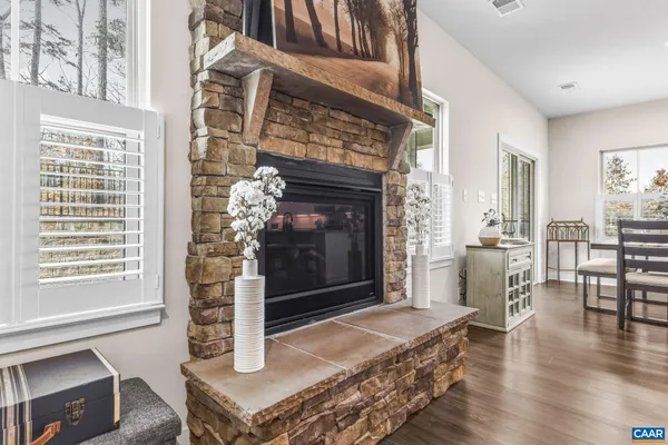 a living room with lots of furniture and kitchen view with wooden floor