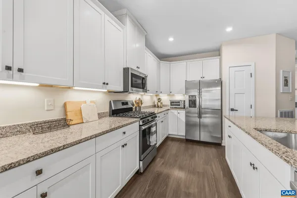 a kitchen with sink stove and cabinets