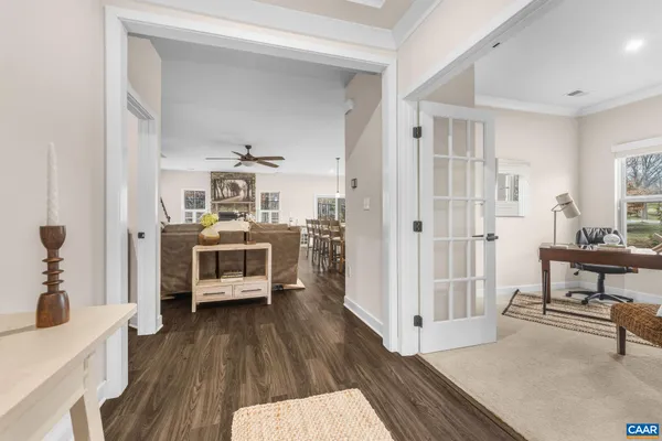 a view of a hallway with wooden floor and furniture