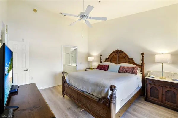 a bedroom with a bed and a chandelier