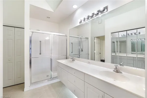 a bathroom with a double vanity sink mirror and double