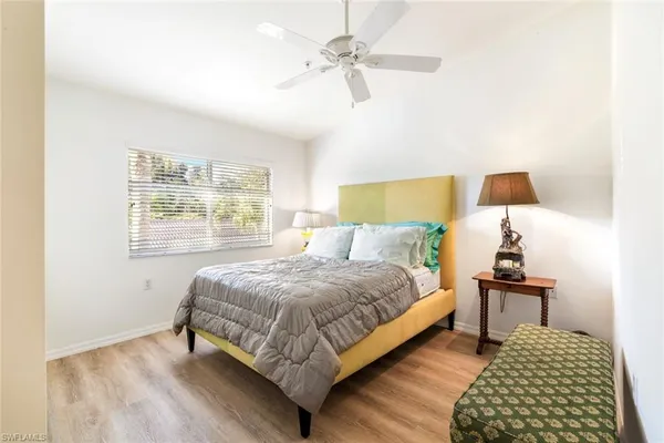 a bedroom with a bed and a lamp