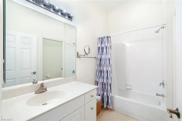 a bathroom with a sink a mirror and a bathtub