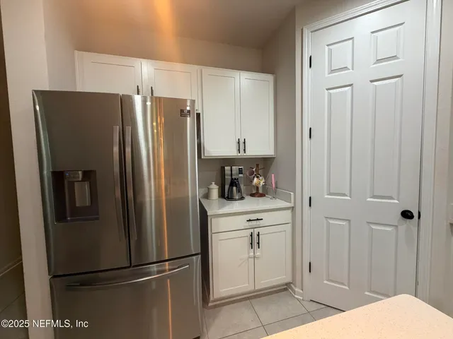 a kitchen with stainless steel appliances a refrigerator and cabinets