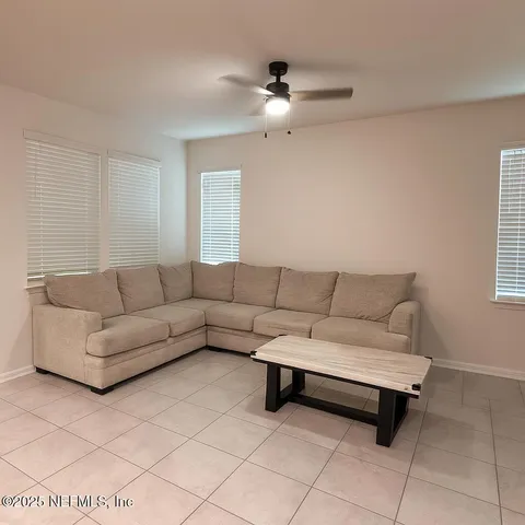 a living room with furniture and a chandelier