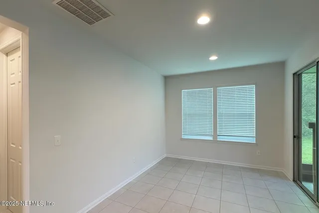 an empty room with windows and closet